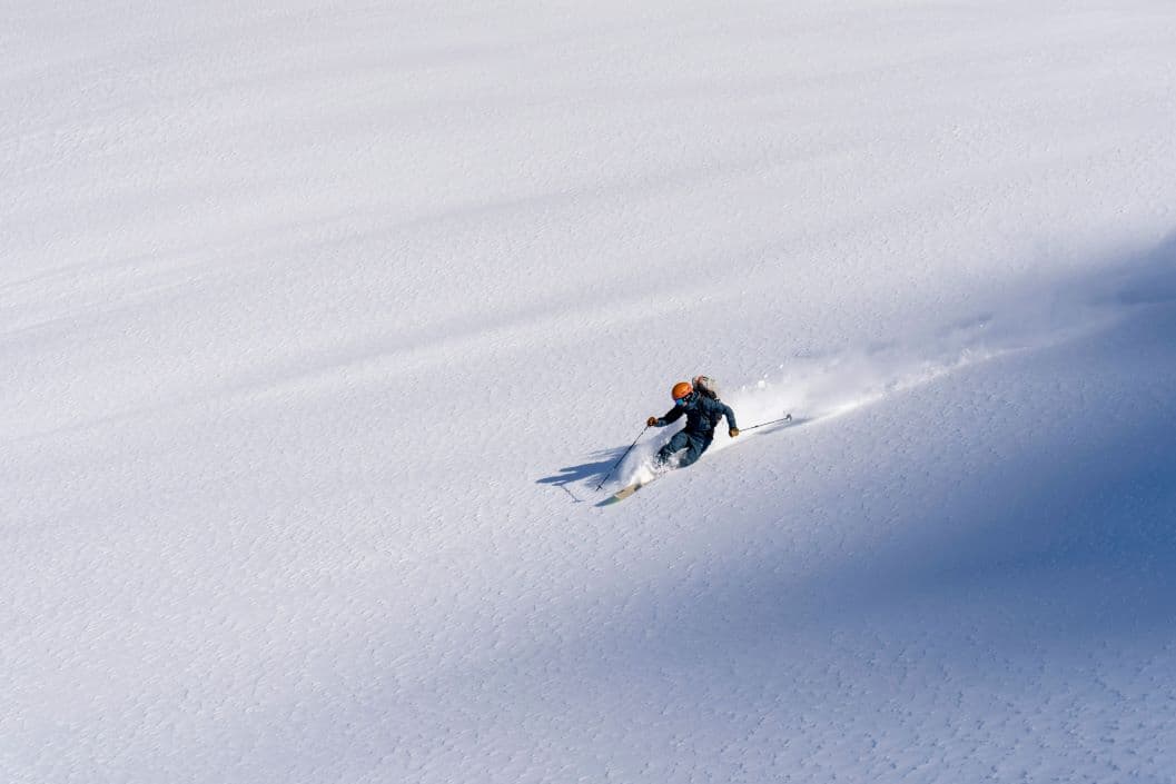Skier in Alpine scenery representing an Austria versus Italy ski holiday